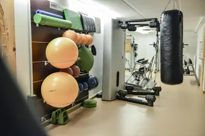 a gym with a punching bag and weights at Mountainlodge Luxalpine in San Vigilio Di Marebbe