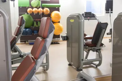 a gym with chairs and balls in the background at Mountainlodge Luxalpine in San Vigilio Di Marebbe