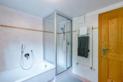 a bathroom with a shower and a bath tub at Grossgasteigerhof in Selva dei Molini