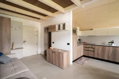 a living room with a couch and a kitchen at Prà Lisandro in Cavalese
