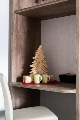 a shelf with two coffee cups and a christmas tree at Prà Lisandro in Cavalese