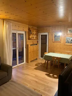 a dining room with a table in a cabin at Pragma Apartments - Appartamento Arcade in Predazzo