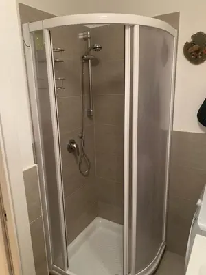 a shower with a glass door in a bathroom at Pragma Apartments - Appartamento Arcade in Predazzo