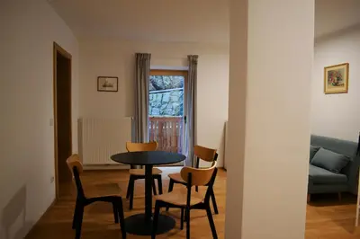 a dining room with a table and chairs in a room at Gasthof Faust in Vols am Schlern