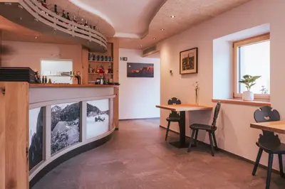 a restaurant with a fish tank in the middle of a room at Gasthof Faust in Vols am Schlern