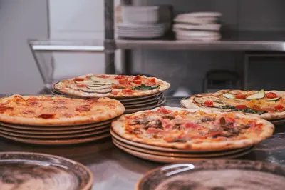 a group of pizzas sitting on top of plates at Gasthof Faust in Vols am Schlern