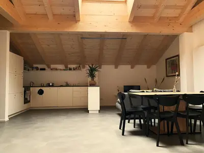 a kitchen and dining room with a table and chairs at Gasthof Faust in Vols am Schlern