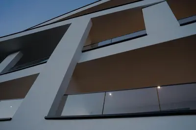 a building with large windows on the side of it at The Hills Merano in Merano