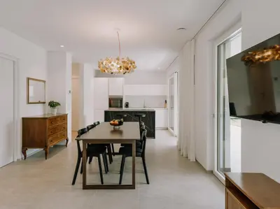 a dining room and kitchen with a table and chairs at The Hills Merano in Merano