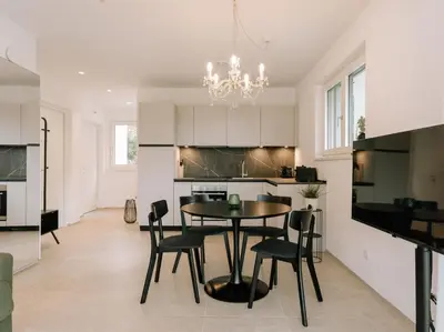 a kitchen and dining room with a table and chairs at The Hills Merano in Merano