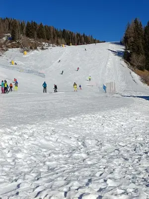 a group of people standing on a snow covered ski slope at Casa Pisolo - presso Sussy Residence in Falcade