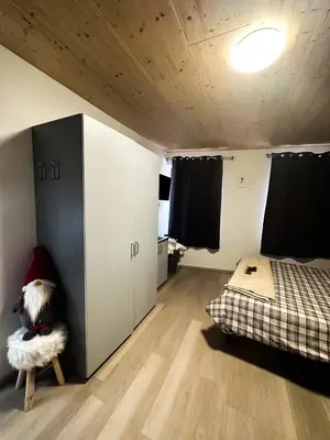 a room with a bedroom with a bed and a table at B&B Piazza in Fondo