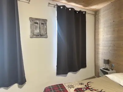 a bedroom with a bed and a black curtain at B&B Piazza in Fondo