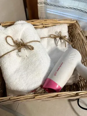 a basket with towels and a hair dryer in it at B&B Piazza in Fondo