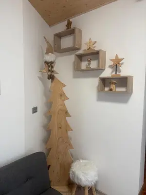 a living room with a christmas tree on the wall at B&B Piazza in Fondo