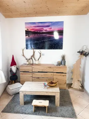 a living room with a table and a picture on the wall at B&B Piazza in Fondo