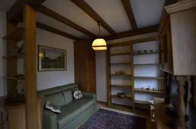 a living room with a green couch and shelves at One bedroom apartment on the promenade in Maion
