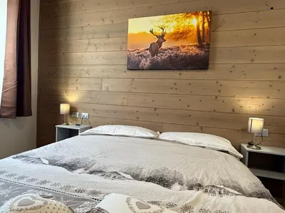 a bedroom with a bed with a painting on the wall at Appartamento vacanze Piazza in Fondo