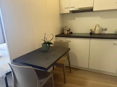 a kitchen with a table and chairs in a room at Appartamento vacanze Piazza in Fondo