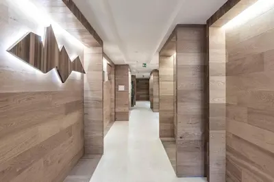 a hallway with wood paneling and a long corridor at Dichterstube im Living Kampill in Bolzano