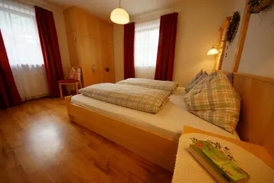 a bedroom with a bed with two pillows on it at Apartments Nevada in Colfosco
