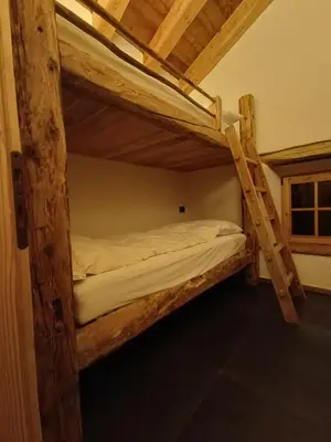 a couple of bunk beds in a room at Brand new Duplex in the Dolomites - Picchio Rosso in Rocca Pietore