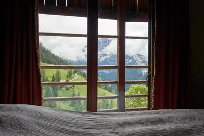 a bedroom window with a view of a mountain at Beautiful barn with garden and stunning view in Colle Santa Lucia