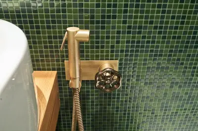 a shower in a green tiled bathroom at Beautiful barn with garden and stunning view in Colle Santa Lucia