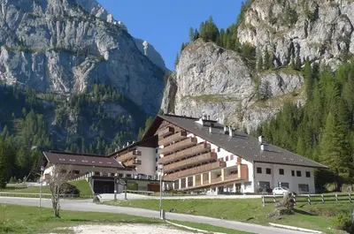 a large building in front of a mountain at Dolomitissime Holiday Homes Marmolada in Rocca Pietore