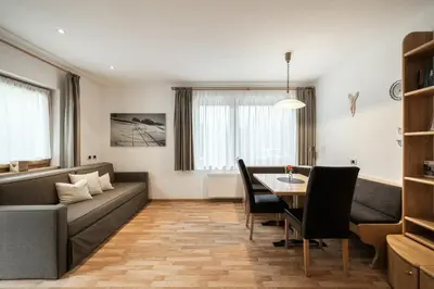 a living room with a couch and a table at Haus Gabi Runggaldier in San Pietro in Gardena