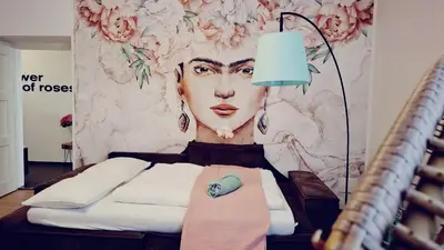 a room with a wall with a painting of a woman at Apartment wildflower in Privatvilla im Herzen Merans in Merano