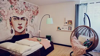 a bedroom with a mural of a woman at Apartment wildflower in Privatvilla im Herzen Merans in Merano