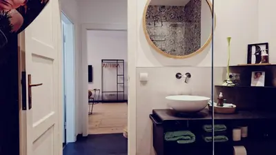 a bathroom with a toilet and a sink and a mirror at Apartment wildflower in Privatvilla im Herzen Merans in Merano