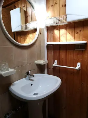a bathroom with a white sink and a mirror at Appartamento Pepe by Sunhome Fiemme in Castello di Fiemme