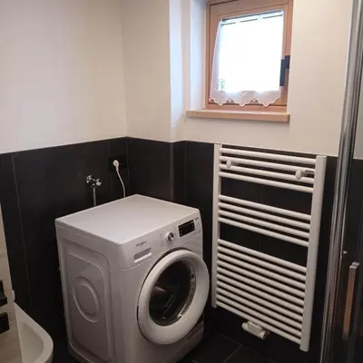 a washing machine in a bathroom with a window at Tabia' Cemin in Predazzo