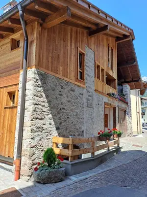 a building with a bench in front of it at Tabia' Cemin in Predazzo