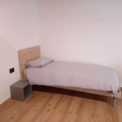 a bedroom with a bed and a night stand at Tabia' Cemin in Predazzo