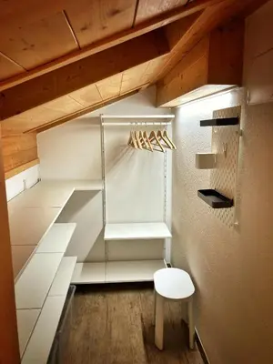 a closet with white shelves and a wooden ceiling at Ad Alba di Canazei una finestra sulla Marmolada in Alba di Canazei