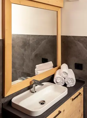 a bathroom with a sink and a mirror at Antico Borgo Palue in Sottoguda