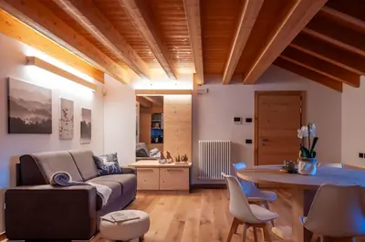 a living room with a couch and a table at Antico Borgo Palue in Sottoguda