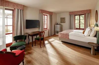 a bedroom with a bed and a desk and a television at Castel Sallegg Suites Adults only in Caldaro