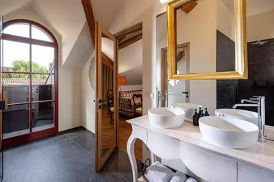 a bathroom with three sinks and a mirror at Castel Sallegg Suites Adults only in Caldaro