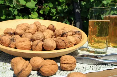 a bowl of walnuts on a table next to a glass of beer at Müllerhof in Kastelruth