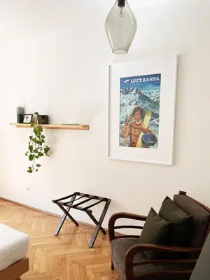 a living room with a couch and a picture on the wall at Late Checkout Merano - 3 Zimmer, Sonnenterrasse, Garage in Merano