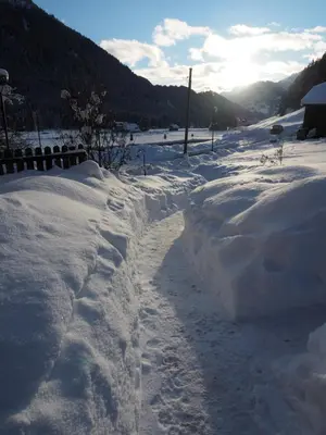 a snow covered road with footprints in the snow at Appartamenti Residence Rodolon Fontanazzo in Campestrin