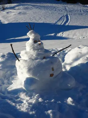 a snowman made out of snow in the snow at Appartamenti Residence Rodolon Fontanazzo in Campestrin