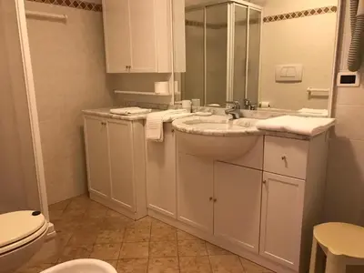 a white bathroom with a sink and a toilet at Appartamenti Residence Rodolon Fontanazzo in Campestrin