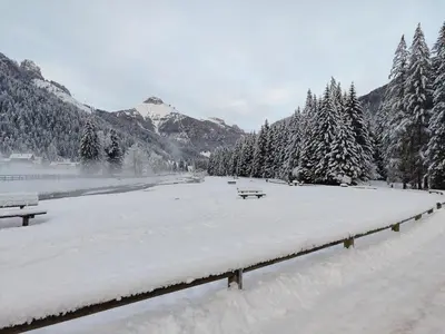a park covered in snow with benches and trees at Appartamenti Residence Rodolon Fontanazzo in Campestrin