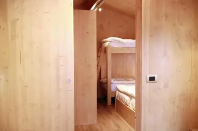 a small room with two bunk beds in it at International Camping Olympia in Cortina dʼAmpezzo