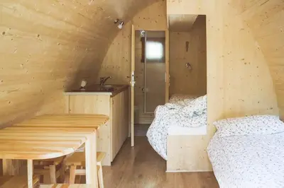 a room with two beds in a wooden cabin at International Camping Olympia in Cortina dʼAmpezzo